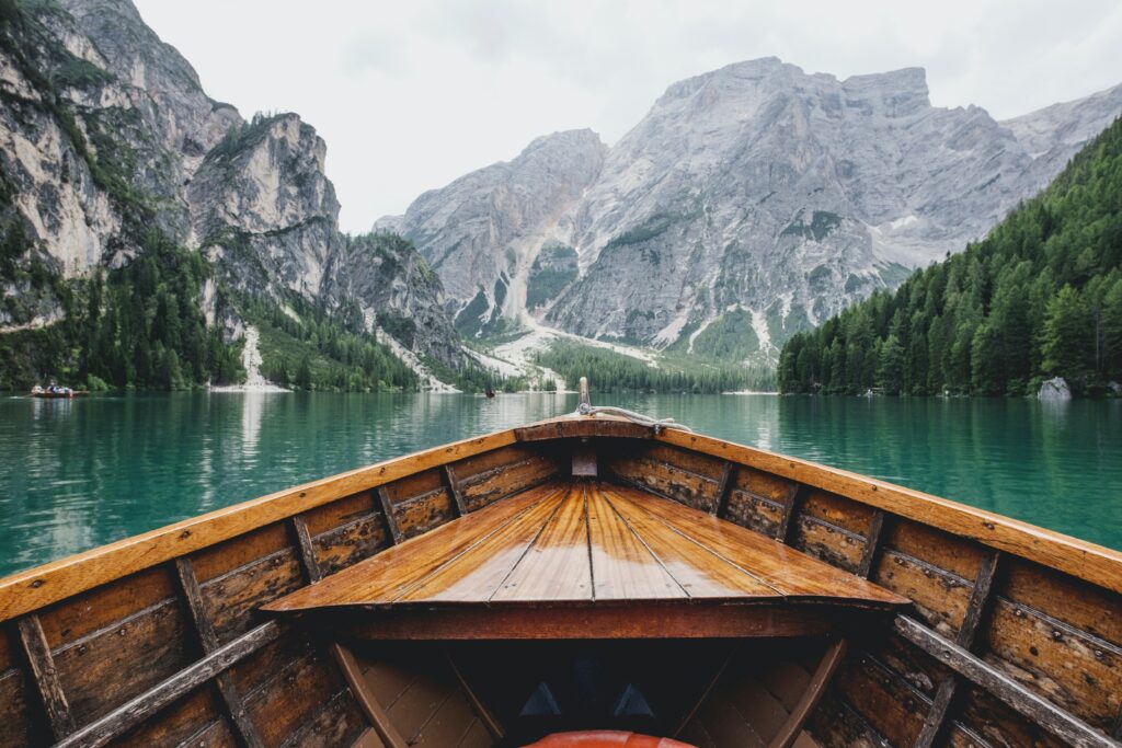 Canoe on calm lake with mountains around